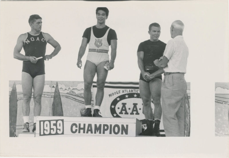 Photo of Tommy Kono on the winner's podium at a competition