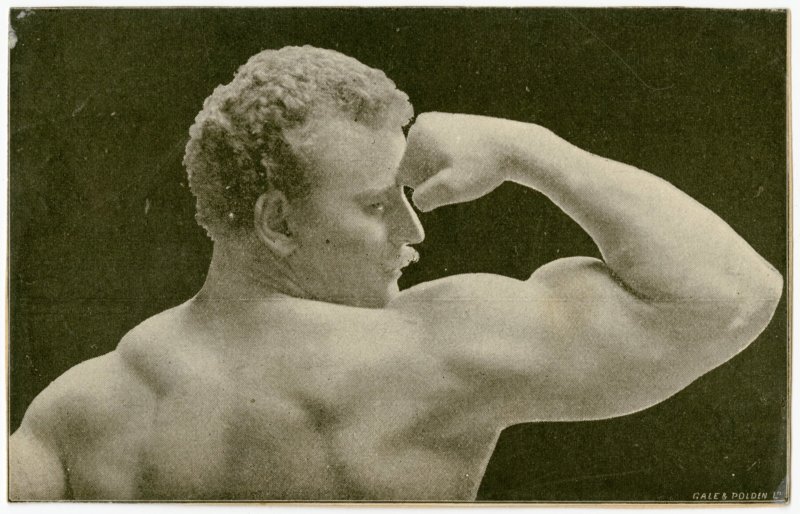 Eugen Sandow flexing right arm