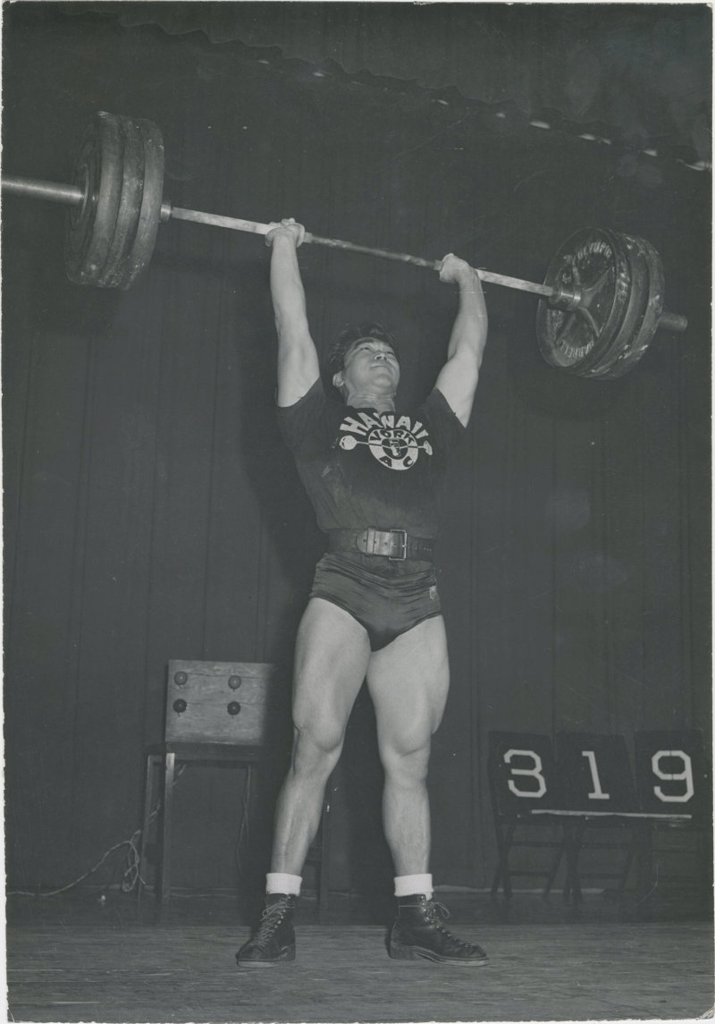 Tommy Kono setting a new world record press of 319 lbs