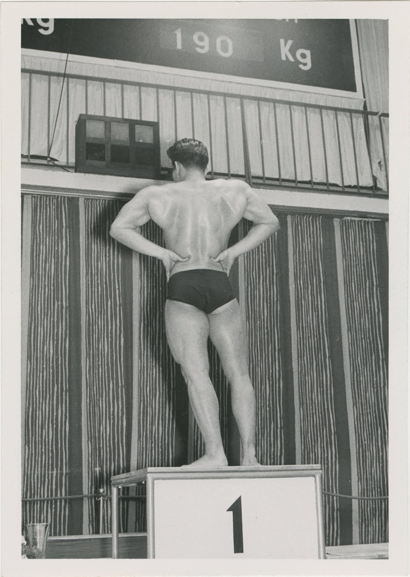 Photo of Tommy Kono posing on a winner's podium